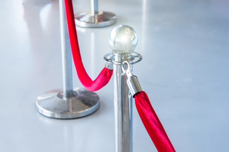 Portable Barrier for Queue Control. Red security rope by red carpetの写真素材