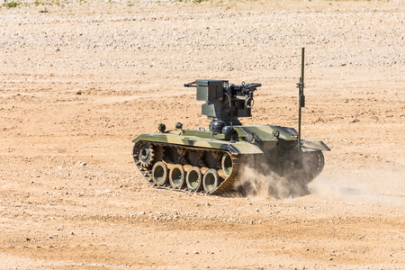 Maneuverable small armored personnel carrier with automatic weapons rides cross-countryの写真素材