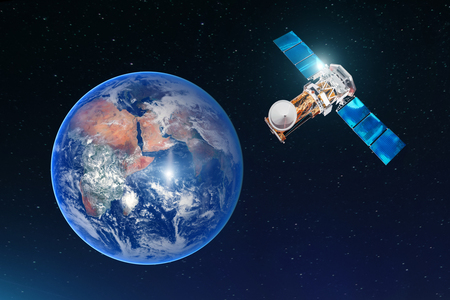 Satellite telecommunication connection, transmits radio communication on the geostationary orbit of the Earth. Against the background of the planet.の写真素材