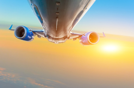 Passenger plane flies in the sky against the background of cirrus cloudsの写真素材