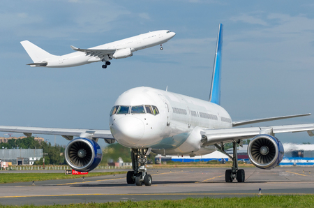 Take off aircraft and another airplane taxiingの写真素材
