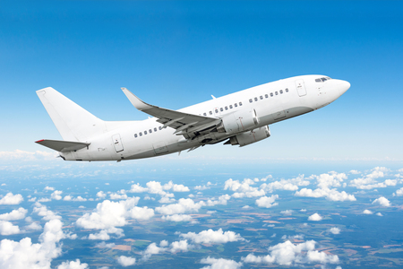 Airplane in the sky above the clouds flight journey sun height.の写真素材