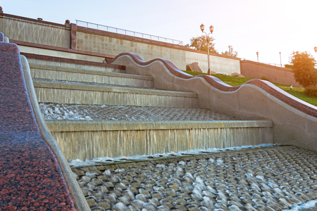 Fountain with a cascade of running water through a granite ladderの写真素材