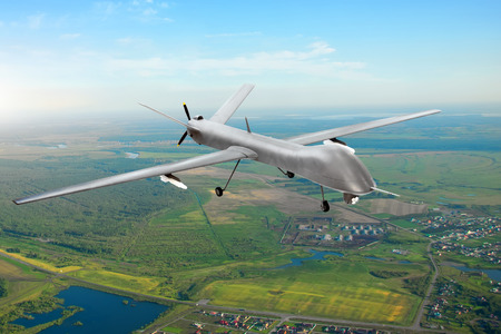 Unmanned military drone on patrol air territory at low altitudeの写真素材