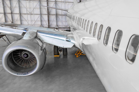 Passenger airplane on maintenance of jet engine and aircraft hangarの写真素材