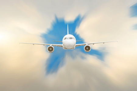 Modern white airplane fly from the lumen into the clouds at high speedの写真素材