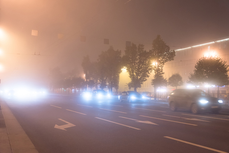 Street lights foggy misty night lamp cars roadの写真素材