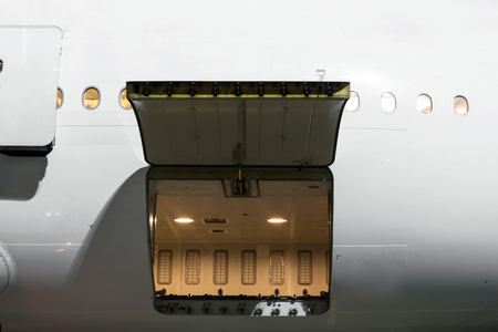 cargo section in the airplane open on inspection, with bags and luggage of passengersの写真素材