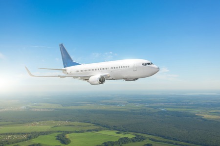 Airplane flying in the blue skyの写真素材