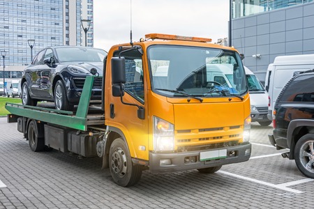 Hatchback car loaded onto a tow truck ready for transportの写真素材