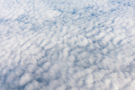 Flying in sky on altocumulus clouds, top viewの写真素材