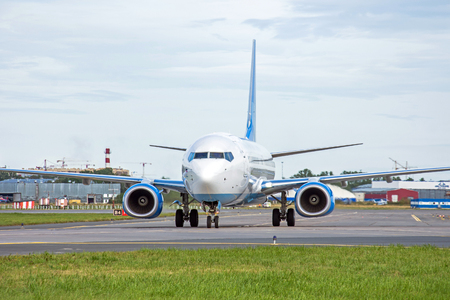 Passenger aircraft taxiing on the apron of the airport on the asphalt is visible markingの写真素材