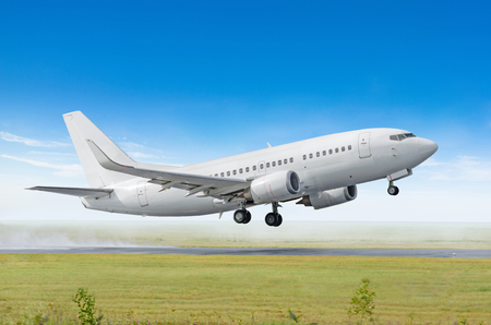 Airplane taking off from the airport, side viewの写真素材