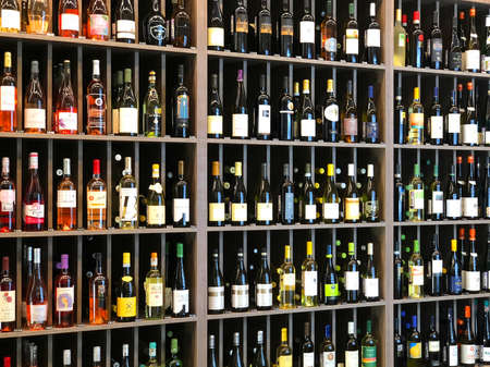 Bottles of various wines on the shelf rack of a store. Russia, Saint-Petersburg, 04 November 2018