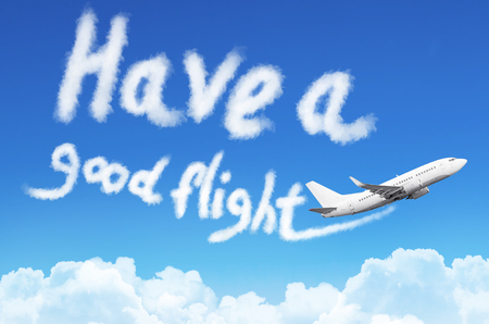 Flying a plane in the sky with the inscription - Have a good flightの写真素材