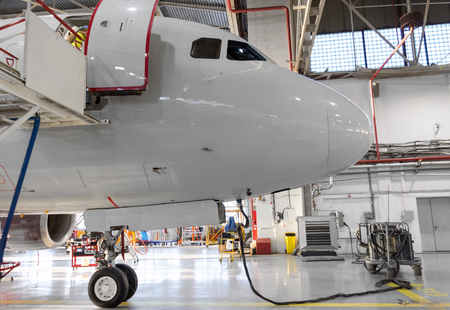 The nose of the aircraft in the hangar, connected autonomous ground powerの写真素材