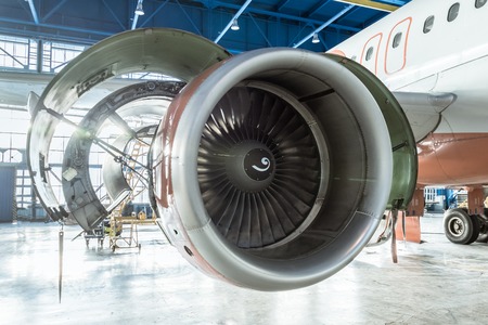 Close up engine jet opened hood aircraft maintenance in the hangar.の写真素材