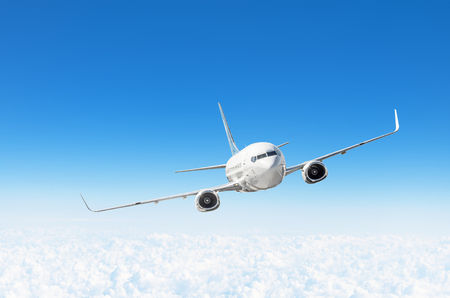 Airplane fly in the blue sky in below the clouds, with space for textの写真素材