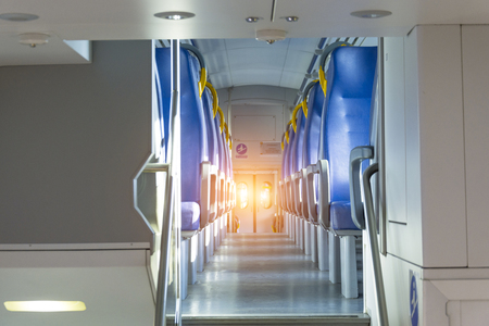 Salon inside of the speed commuter train with empty seatsの写真素材