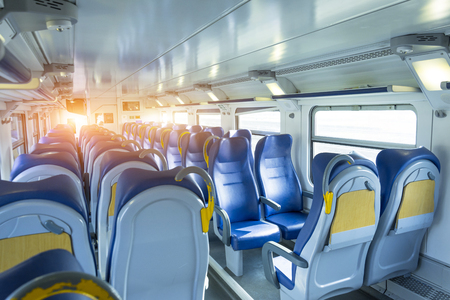 Salon inside of the speed commuter train with empty seatsの写真素材