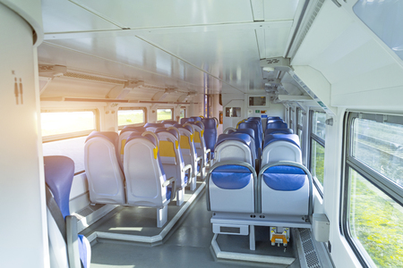Salon inside of the speed commuter train with empty seatsの写真素材