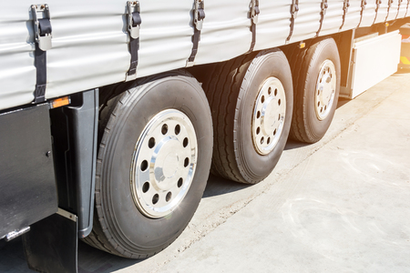 Three shiny chrome wheel of large truck and trailers.の写真素材