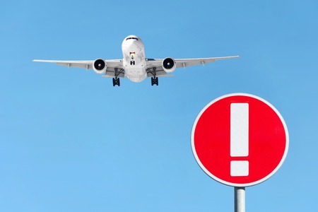 Red sign attention aircraft and an airplane flying in the sky.の写真素材