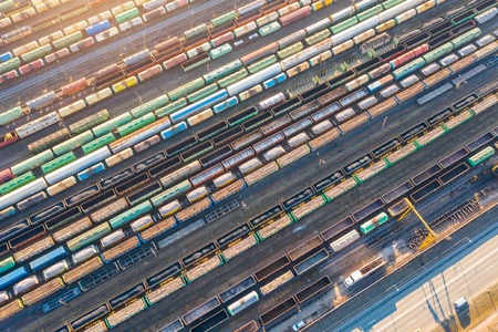 Aerial view of railroad tracks long trains, cargo sorting station. Many different railway cars with cargo and raw materialsの写真素材