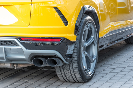 Dual exhaust pipe, view of the wheel of the carの写真素材