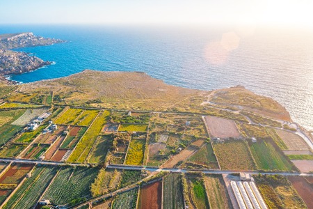 Aerial view of the various fields of crops, on the cliff of the Mediterranean Sea sunset horizonの写真素材