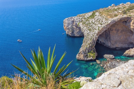 Blue Grotto rock cliff arch in Malta, aerial view from the Mediterranean Sea to the islandの写真素材