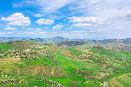 The view from the height aerial of the landscape - the fields and hills of the hill and the summer skyの写真素材