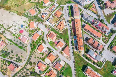 Aerial view town with houses and ceramic tiles, solar panels, streetsの写真素材