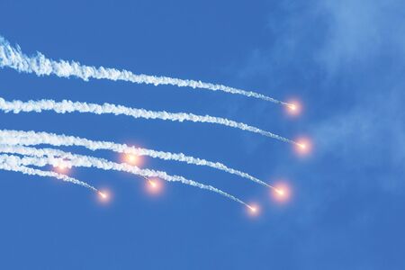 Falling burning flares of several meteorites of asteroids in the day skyの写真素材