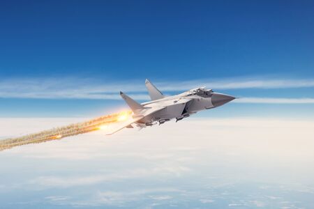 Combat fighter jet on a military mission with weapons - rockets, bombs, weapons on wings flies high...