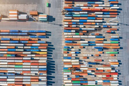 Aerial view of shipping containers on a dock at the port