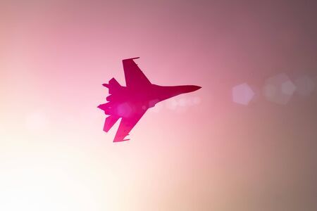 Aircraft fighter jet airplane sun glow warm pink purple red gradient skyの写真素材
