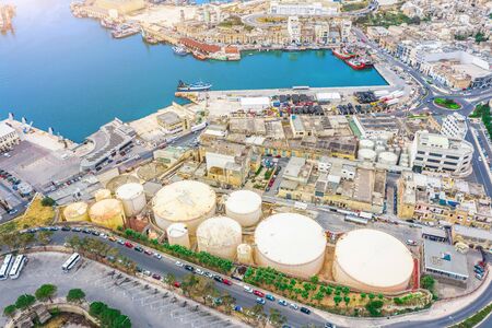 Aerial view of large fuel storage tanks at oil refinery industrial zone in the cargo seaport