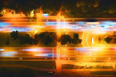 Top aerial view overlook roadway with pedestrian crossing and tree alley night view highlighted by...