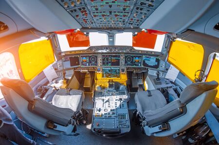 Cockpit in the airplane, wide view of the control panel and pilot seatsの写真素材