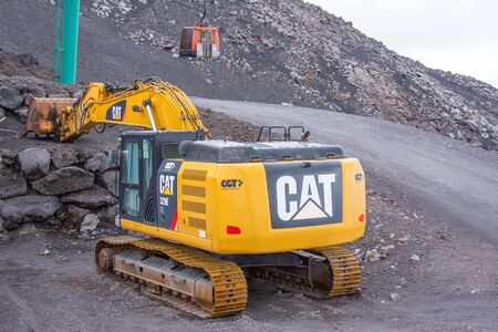 Excavator cat on a road in the mountains. Italy, Catania 12 may 2019のeditorial素材
