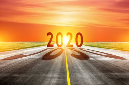 2020 and cast shadow on the road asphalt year with the rising sun in the morning. The concept of the...