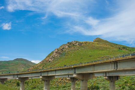Concrete road curve of viaduct among the hillsの写真素材