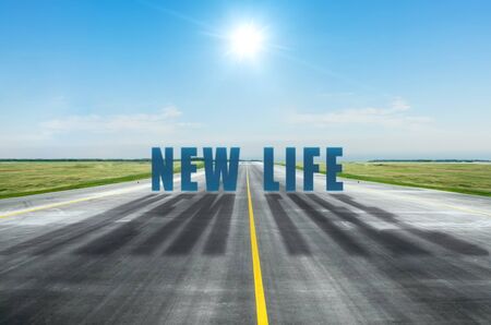 New life change concept with a bright sun in the sky and the inscription on the roadの写真素材