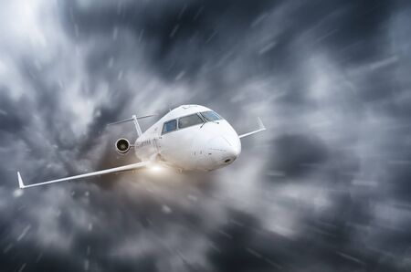 The plane flies during a storm and heavy rain overcastの写真素材