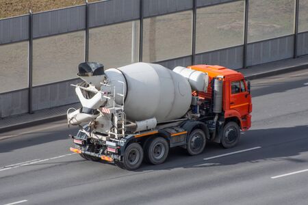 Concrete mixer truck rides on city highwayの写真素材