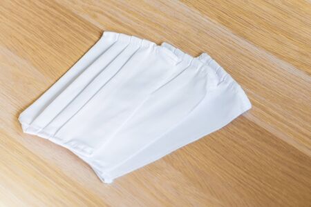 Hygienic medical masks made of white multilayer fabric, protection against the virus during a pandemicの写真素材