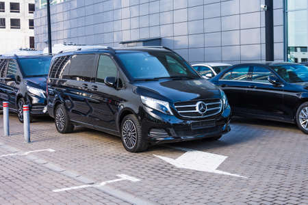 Black Mercedes-Benz V class, front view mini bus in a row in a parking lot. Russia,...