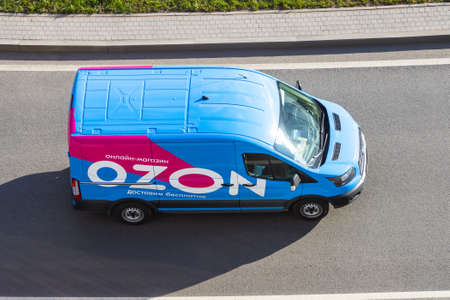Mini van truck for delivery to points of delivery of the online store Ozon.ru rushing rides highway city road. Russia, Saint-Petersburg. 14 april 2020のeditorial素材