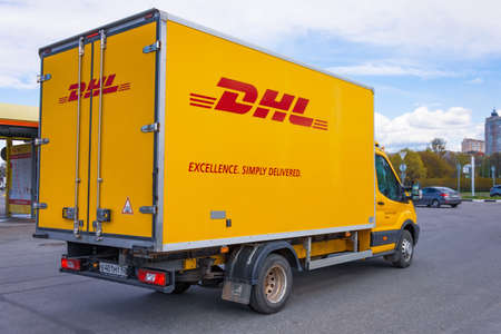 DHL world wide courier company delivery truck on the highway city. Russia, Saint-Petersburg 13 may 2020のeditorial素材